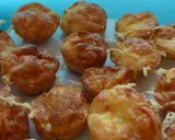 Une assiette de mini quiches sans pâte dorées et appétissantes, garnies de fromage fondu. Parfaites pour un apéritif gourmand.