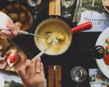 Un délicieux vin blanc pour fondue savoyarde accompagne ce plat réconfortant. Des pommes de terre et du fromage fondent dans le caquelon.
