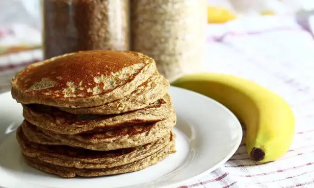Pile de pancakes aux pois chiche, dorés et moelleux, accompagnés d'une banane. Parfait pour un petit-déjeuner sain.
