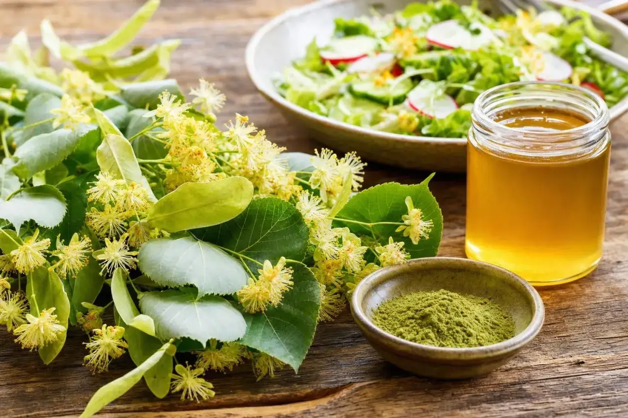 Fleurs de tilleul fraîches, une poudre verte et un pot de sirop de tilleul doré sur une table en bois.