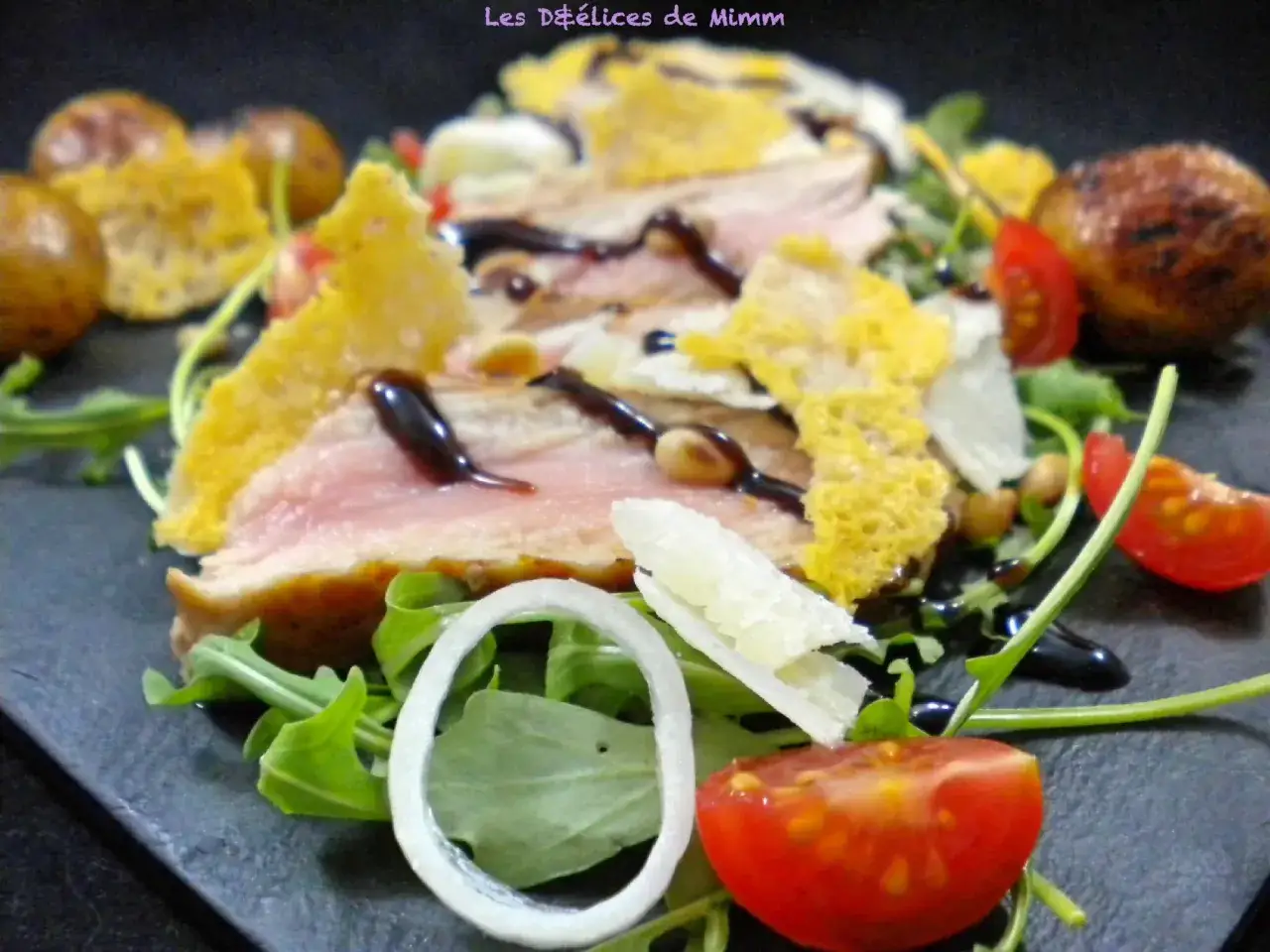 Délicieuse tagliata de veau, garnie de roquette, tomates cerises, oignons, copeaux de parmesan et croquant de fromage.